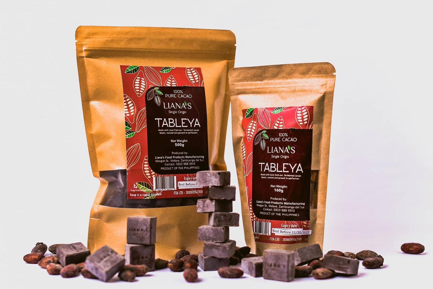 Liana's Tableya 500 g and 160 g pouches with stacked tableya tablets and cacao beans